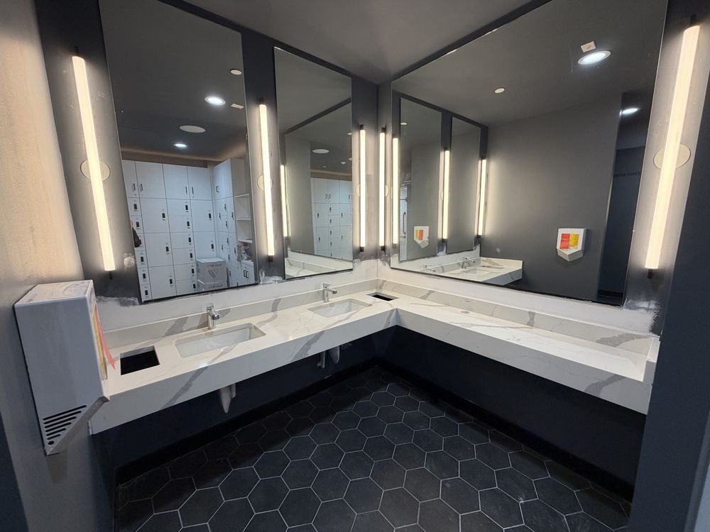 Commercial restroom vanity in Calacatta-look quartz