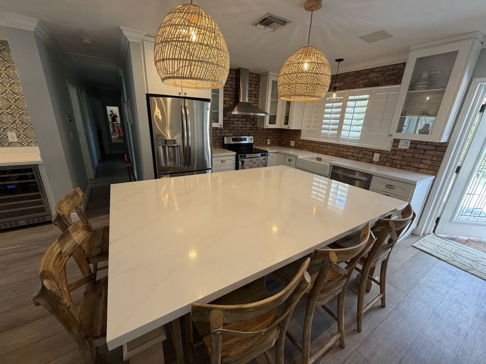 Bright kitchen with a Calacatta-look quartz waterfall island