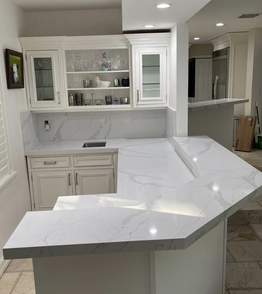 Kitchen with a white waterfall-edge island