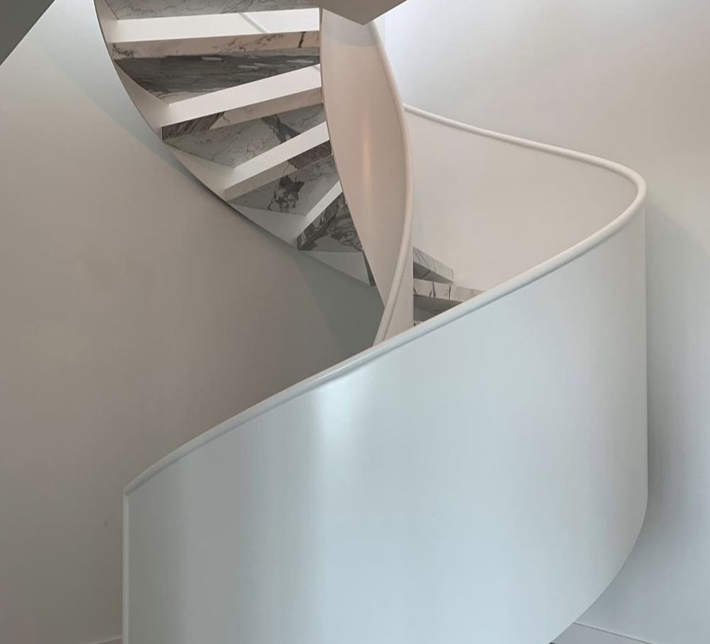Curved staircase finished with marble treads